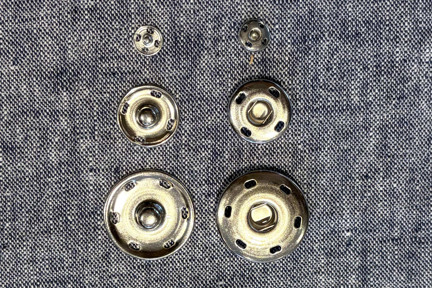 Metal buttons on a textured fabric background