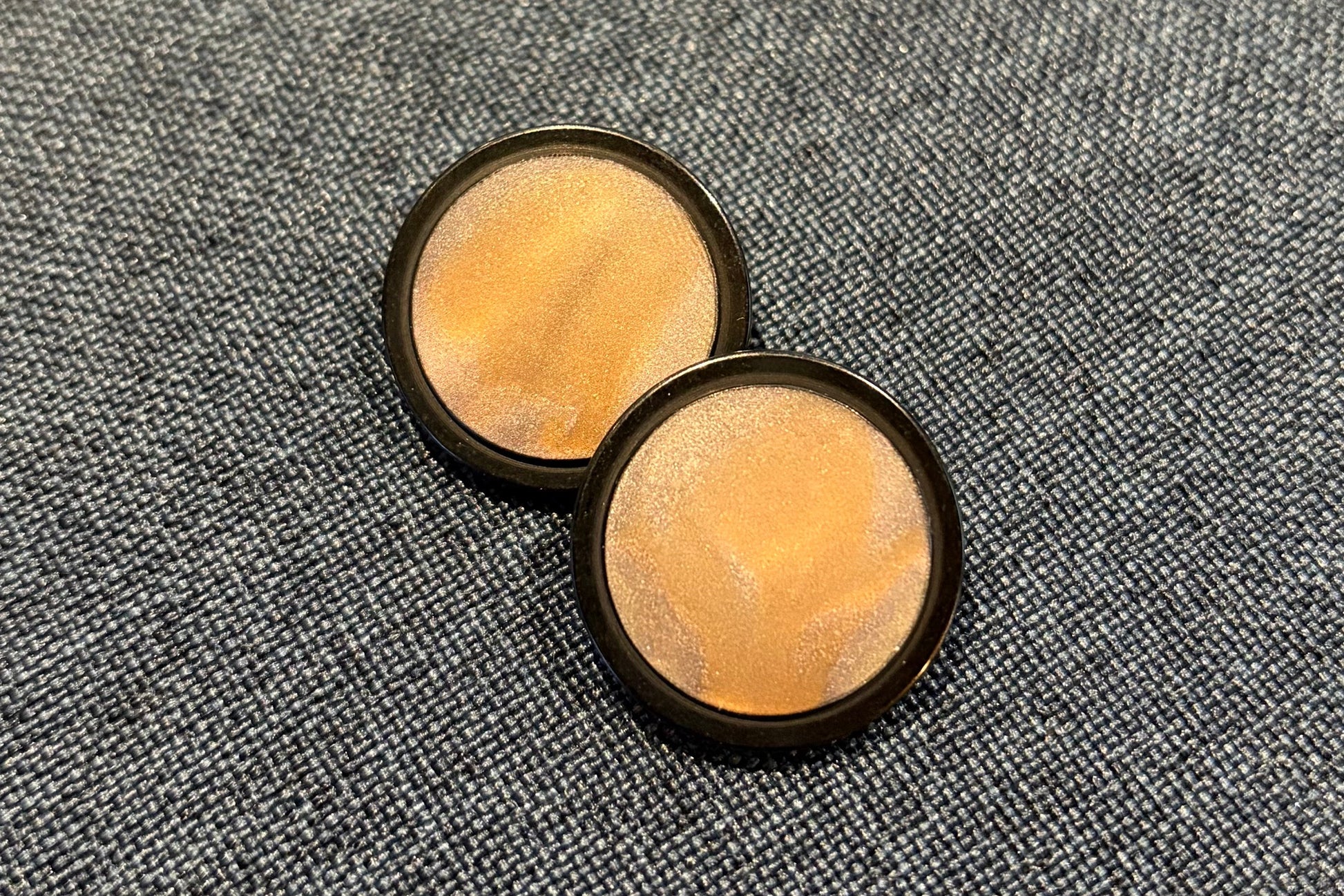 Two buttons with black edge and golden centres