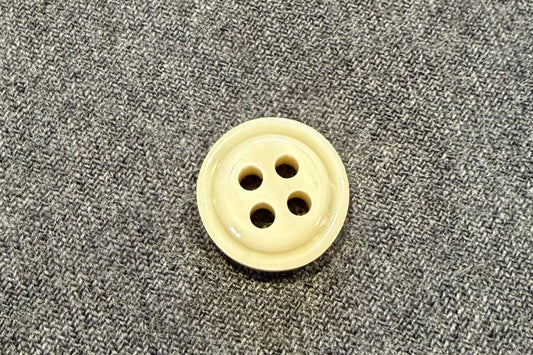 Button on a gray fabric surface