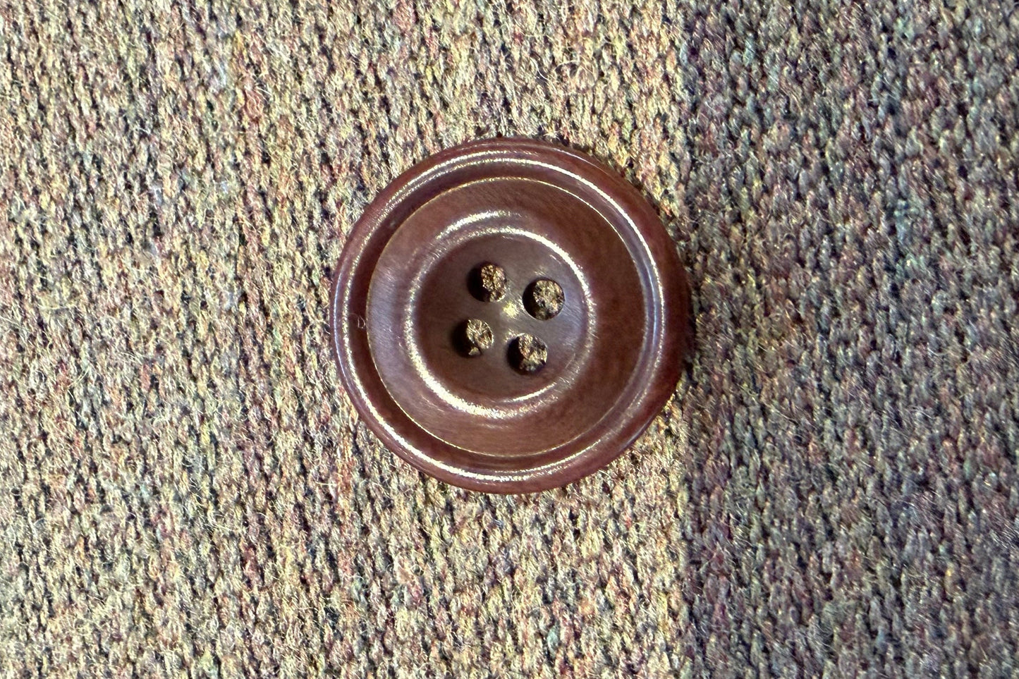 Brown button on a textured fabric background
