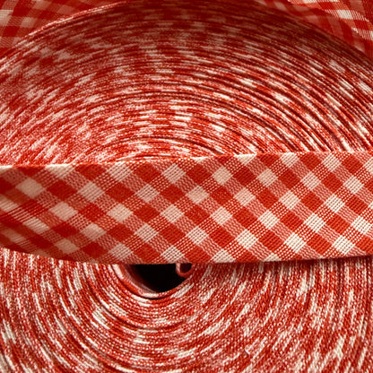 Orange and white gingham cotton bias tape on the roll