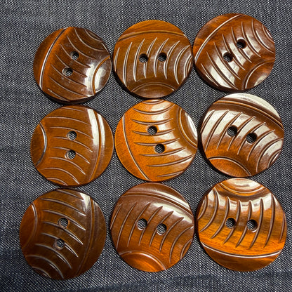 Carved brown casein shank button that looks like wood.