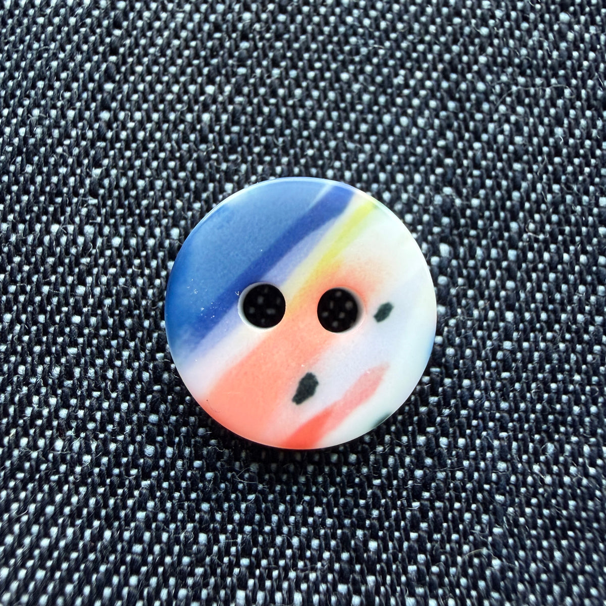 Whimsical patterned plastic shirt buttons in six prints on denim