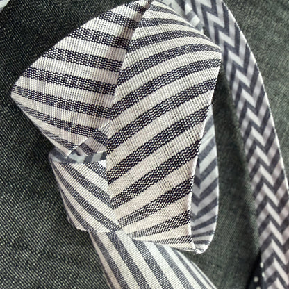 Grey and white striped cotton bias tape on the roll