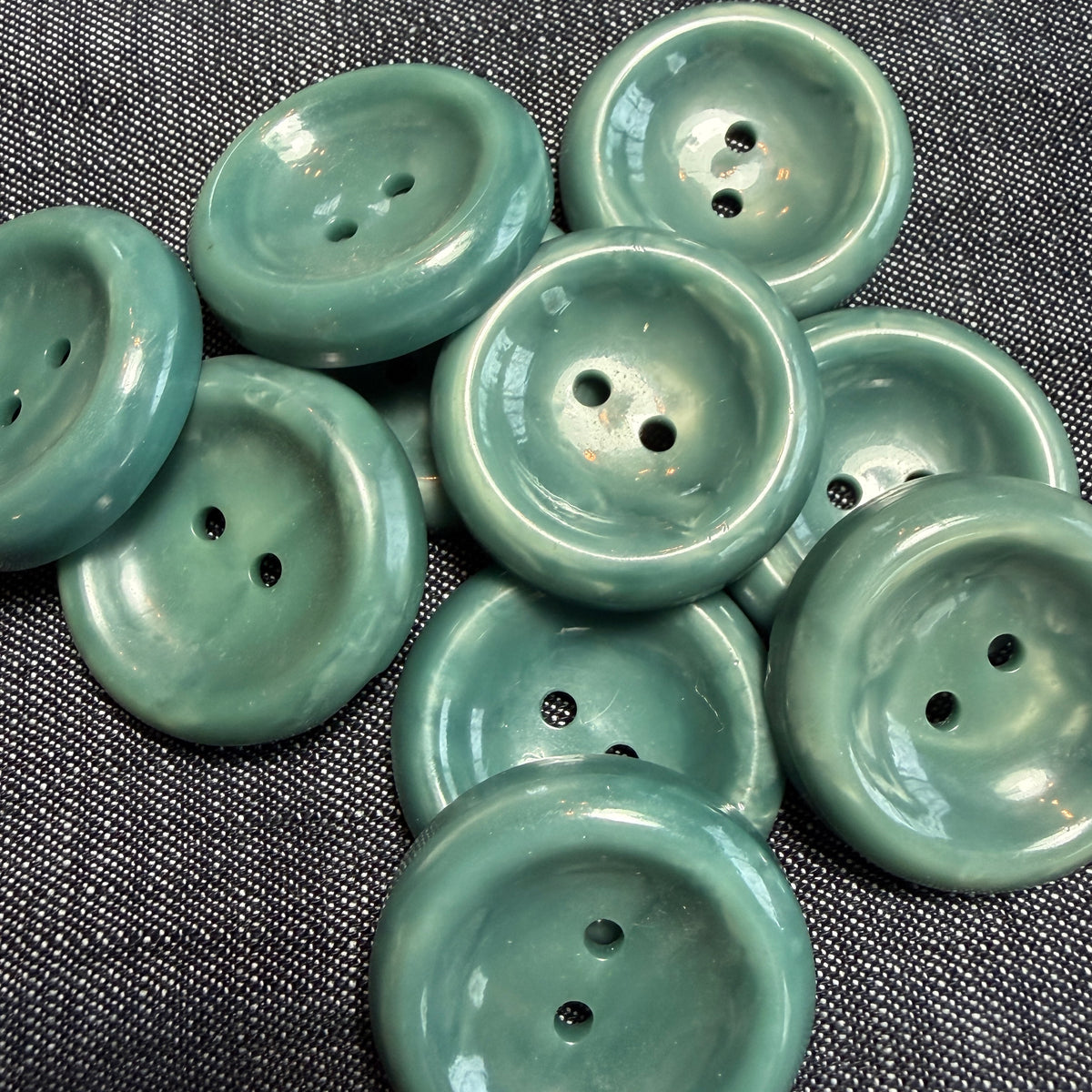 Natural teal casein buttons, 17 mm and 27 mm, handmade in Argentina.