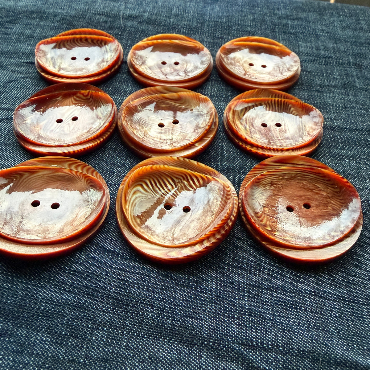 Rows of rust and copper two-hole statement buttons handmade in Argentina.