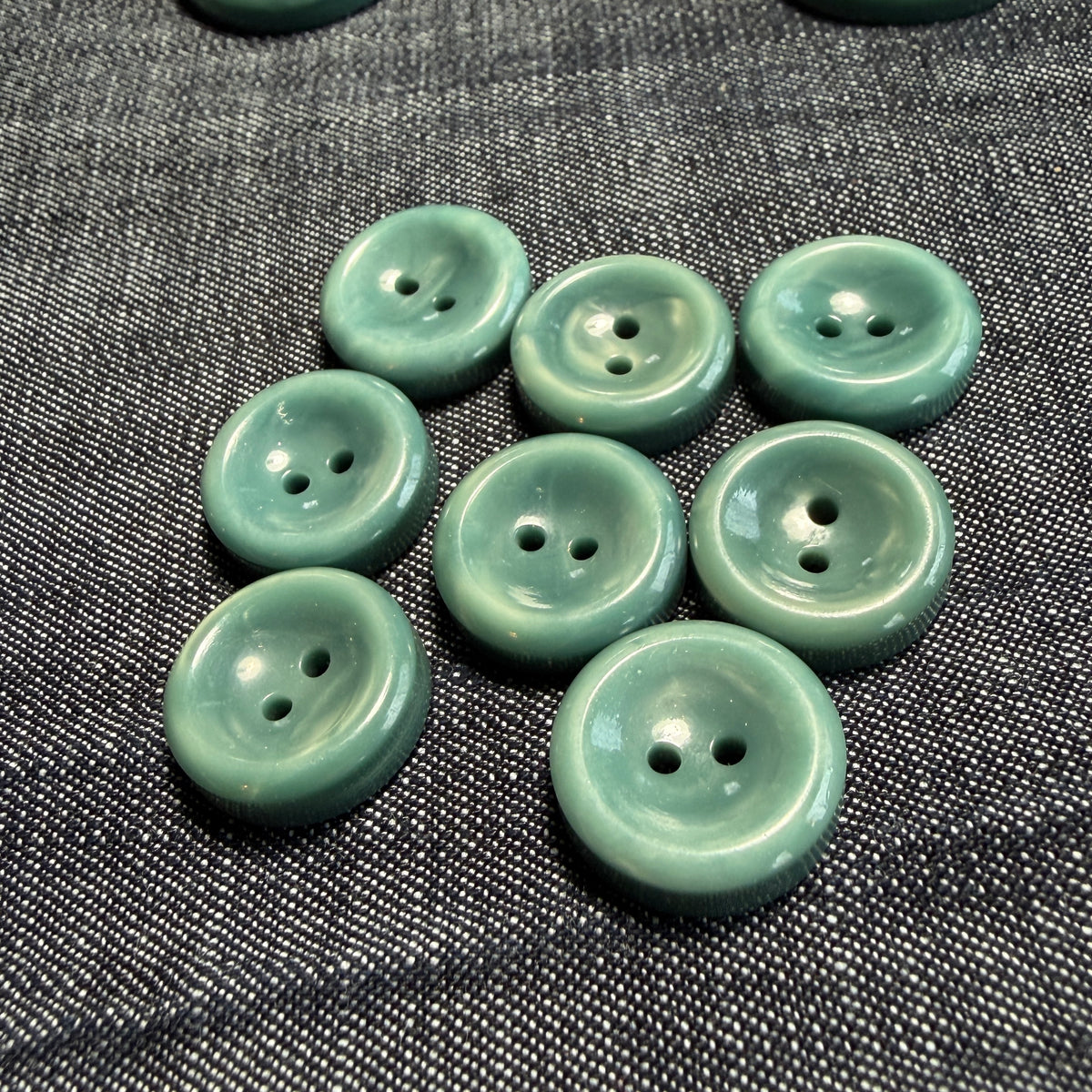 Natural teal casein concave buttons in 17 mm and 27 mm.