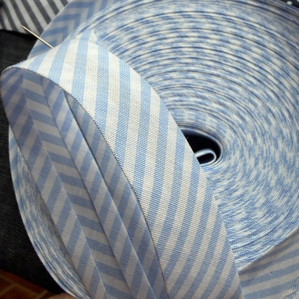 Blue and white striped cotton bias tape on the roll