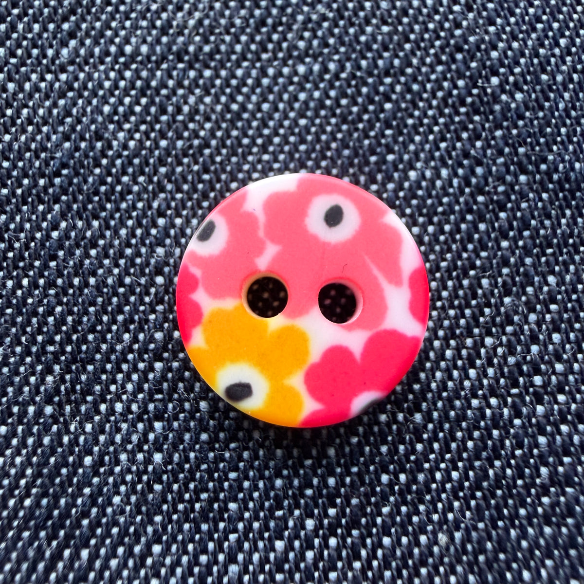 Whimsical patterned plastic shirt buttons in six prints on denim