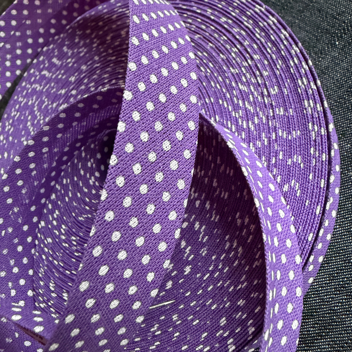 Purple polka dot cotton bias tape on the roll