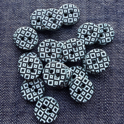 Whimsical patterned plastic shirt buttons in six prints on denim