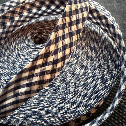 Black and white gingham cotton bias tape on the roll