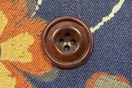 Floral fabric with a button on a blue background