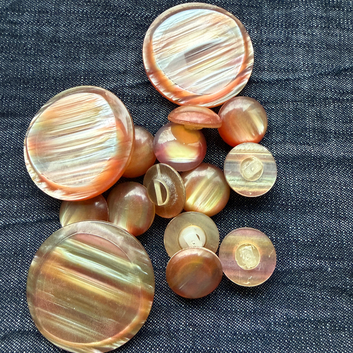 Rose-gold casein statement buttons grouped with the matching small domed cuff buttons.