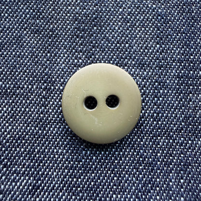 Close-up of a matte olive two-hole plastic button