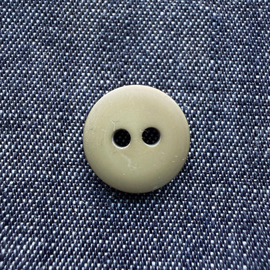 Close-up of a matte olive two-hole plastic button