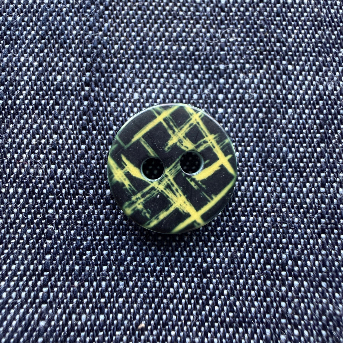 Whimsical patterned plastic shirt buttons in six prints on denim