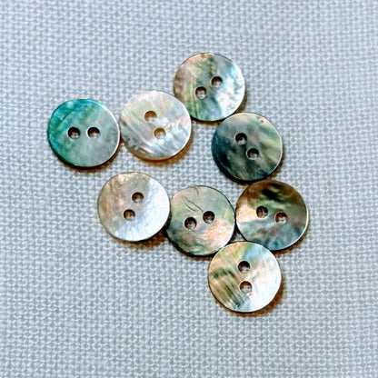 Set of round, multicolored buttons on a textured gray background